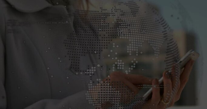 Animation of globe over hands of caucasisn woman using tablet