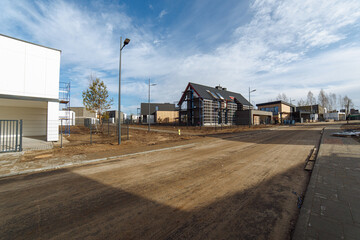 Fototapeta na wymiar road improvements in a new private neighborhood with designer houses