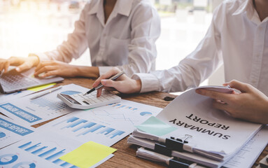 Young colleagues discussing business and price chart analyzes business people on the table great in modern coworking office teamwork concept.