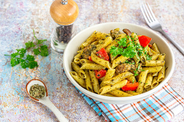 Chicken Pesto Pasta in a Bowl Garnished with Fresh Parsley Leaves