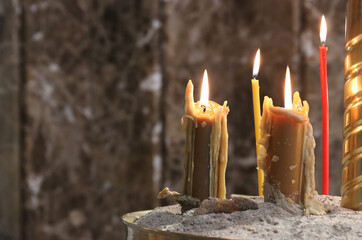 Wax candle burning in the church.