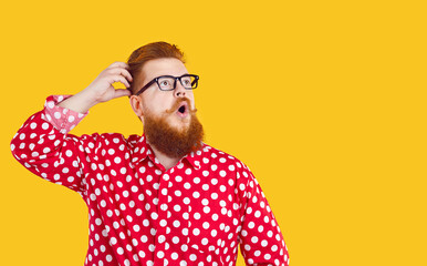 Bearded chubby man with shocked and amazed facial expression on orange background. Surprised...