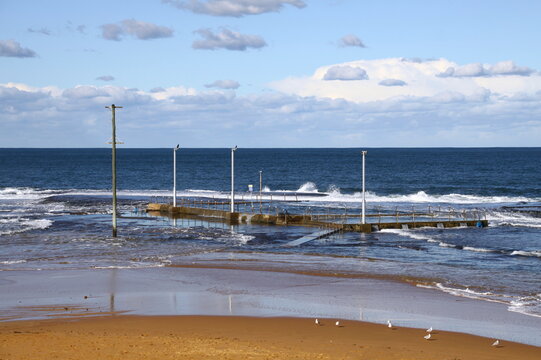 Empty Mona Vale Rock Pool washed with waves in high tide. 