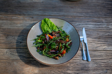 Fresh vegetable salad of tomatoes, cucumbers, italian mix, lettuce.