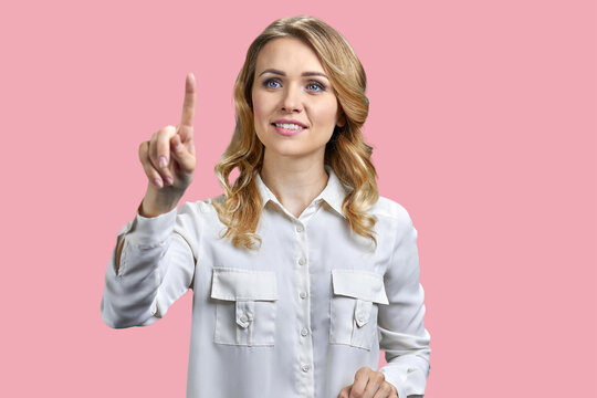 Pretty business lady working with virtual screen on color background. Beautiful office woman pressing button on virtual screen.