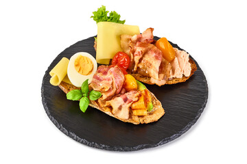 Bruschetta with fried bacon and cheese, isolated on white background. High resolution image.