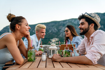 Leisure holidays vacation people and food concept. Happy friends having dinner at summer party