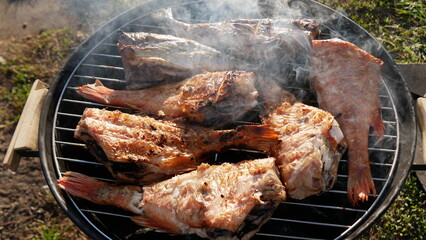 Fish is grilled with smoke. Delicious perch fish dish is cooked on coals.