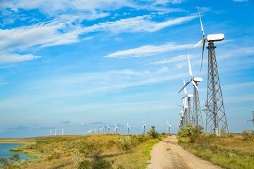 Fototapeta na wymiar Wind turbines on sky background. Green ecological power energy generation.