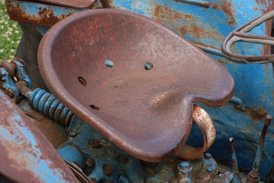 Old rusty abandoned tractor seat