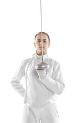 Young girl, fencer in white fencing costume posing with rapier isolated on white background. Sport,...