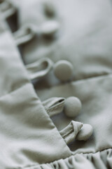 Buttons on the cotton dress closeup. Selective focus.