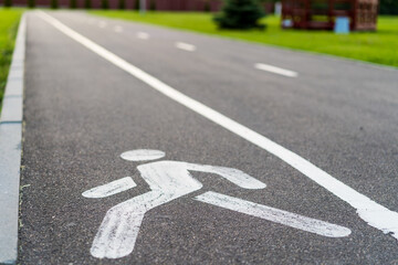 Obraz premium bicycle path, bicycle and running track, pedestrian sign on asphalt