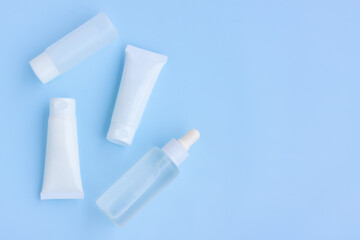 Cosmetic bottles on blue background