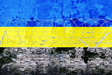 Barbed wire wall with Ukraine flag background