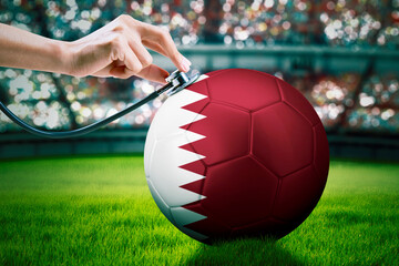 Hands checking a ball with Qatar flag