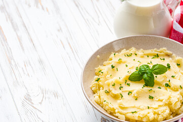 fresh tasty mashed potatoes on a white wooden rustic background