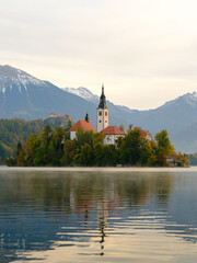 Iconic view of the Lake Bled in Slovenia. Church on an island in the middle of the lake. Summer landscape at dawn.