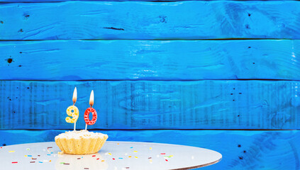  Festive background with a cake on the background of blue boards, copy space, a beautiful...