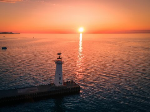 Bird's eye view of a lighthouse on a pier on Sodus Bay, New York at sunset