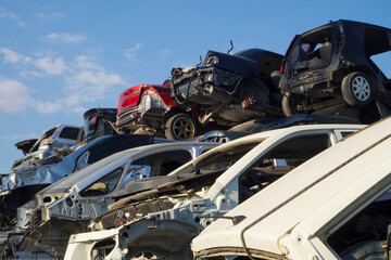 Fototapeta na wymiar Auto graveyard - cars waiting to be recycle in junk yard in Turkey, Ankara - stacked cars in car cemetery 