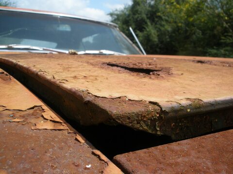 Old Abandoned Car With A Rusty Hood In A Farm