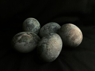 Closeup of decorated Easter eggs on a black surface