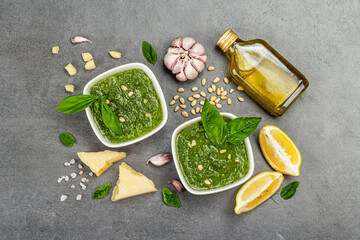 Pesto sauce in a bowls with pine nuts, parmesan and garlic. Traditional Italian food