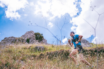 active man training on mountain with trail running
