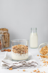 Granola and yogurt parfait in a glass cup, oats and nuts parfait, toasted honey granola with layer of yogurt in glass cup