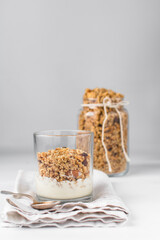 Granola and yogurt parfait in a glass cup, oats and nuts parfait, toasted honey granola on top yogurt in a glass cup 