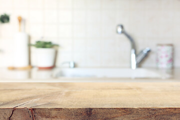 empty table board and defocused modern kitchen background. product display concept