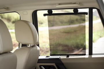 Rectangular black side window sun shade, on a car 