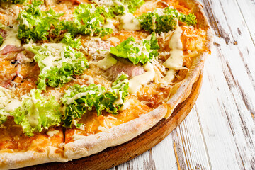 delicious hot traditional italian pizza on a white wooden rustic background