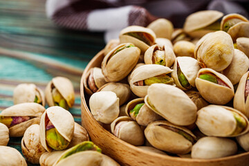 fresh salted pistachios on a wooden rustic background