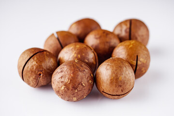 fresh macadamia nuts on a white acrylic background