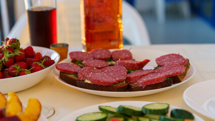 Sandwich with smoked sausage on a white plate