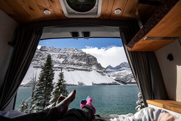 View of the Lake Louise Alberta and the snowy mountains of Canada from the view of campers in a van