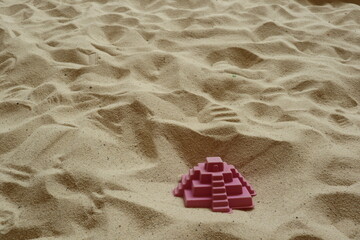 pink plastic toy in the sandpit for design for housing market concept