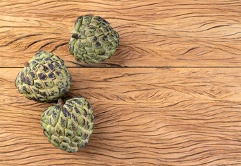 Sugar apples or custard apples over wooden table with copy space