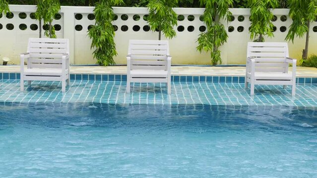 Wavy pool water with bright blue background and grid tiled floor.