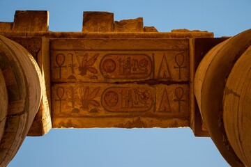 Low angle shot of hieroglyphs on an old gateway in an Egyptian temple