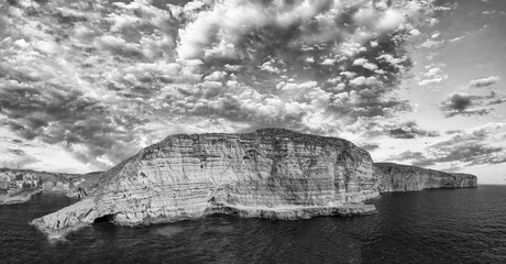 Aerial view of beautiful Xlendi Bay from drone in black and white, Gozo