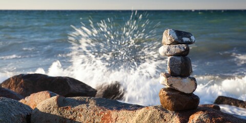 Beautiful view of stones aligned on one another and the sea waves hitting the rocks