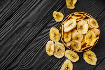 delicious dried banana on a black wooden rustic background