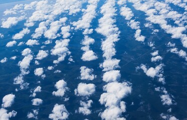 Aerial view of cotton-like clouds over a vast landscape © Buellom/Wirestock Creators