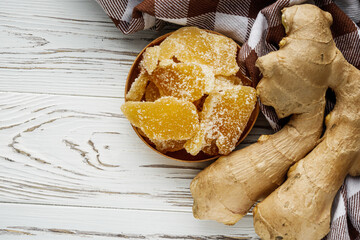 spicy dried ginger on a white wooden rustic background