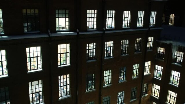light from the windows of the facade of a business building