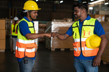 Male staff workers team gshaking hands after successful work at warehouse.