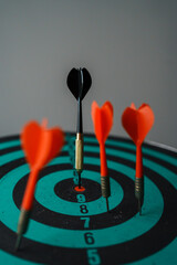 Bullseye is a target of business. Dart is an opportunity and Dartboard is the target and goal. So both of that represent a challenge in business marketing as concept.	
